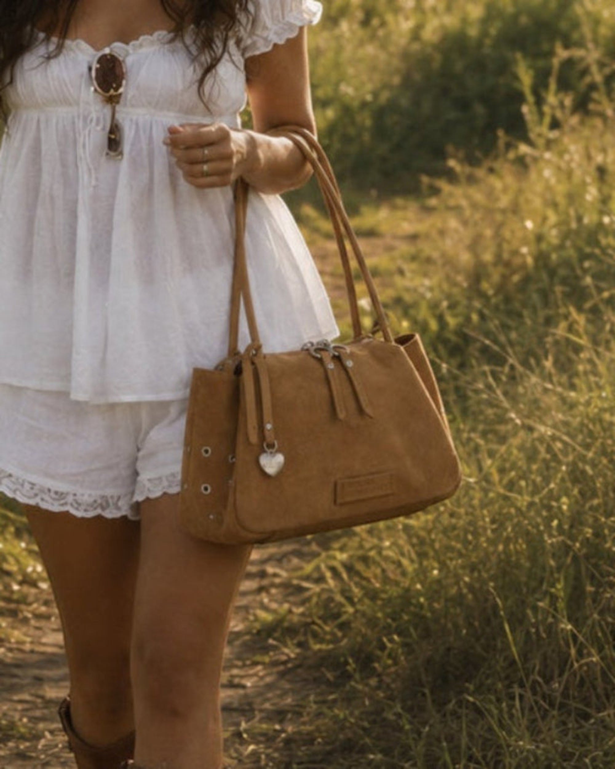 Urban Originals USA tan suede crossbody bag with pebbled vegan leather trim and brushed silver hardware.